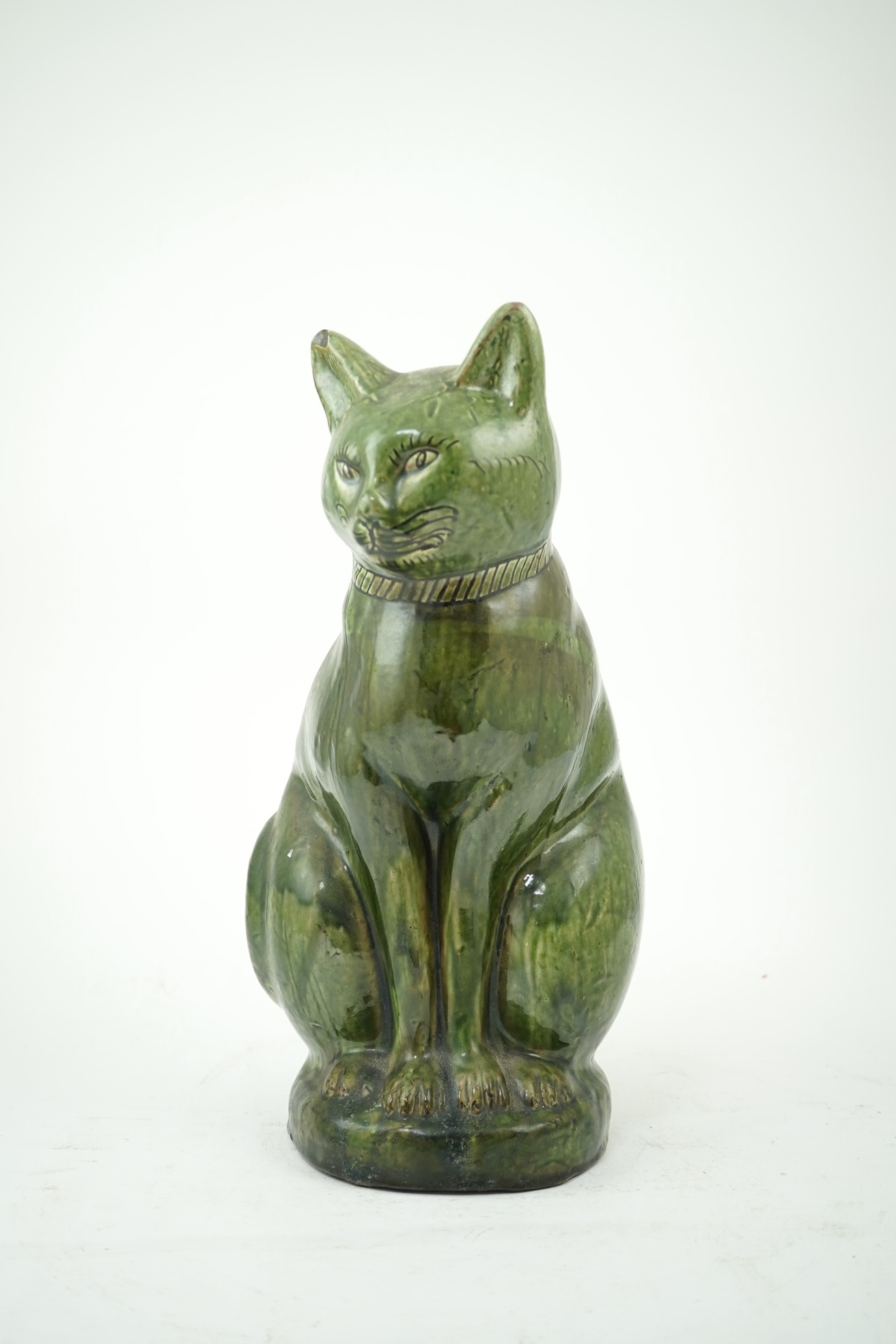 Ewenny Pottery: A large green-glazed figure of a seated cat